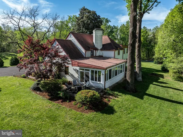 a view of a house with a yard and garden