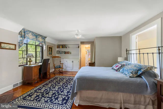 a bathroom with a sink a toilet and a large mirror