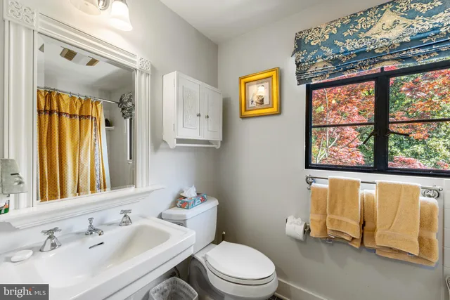 a bathroom with a sink a mirror and a shower