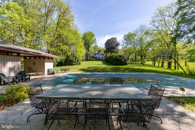 a backyard of a house with table and chairs