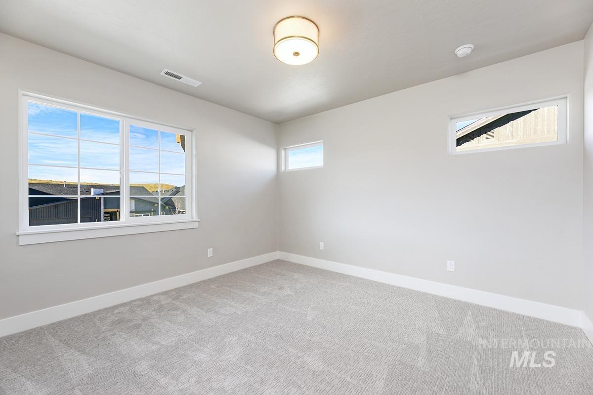 13544 North Ruffed Grouse Place Boise, ID 83714 - Photo 18 of 42 Unfurnished room with baseboards and carpet flooring
