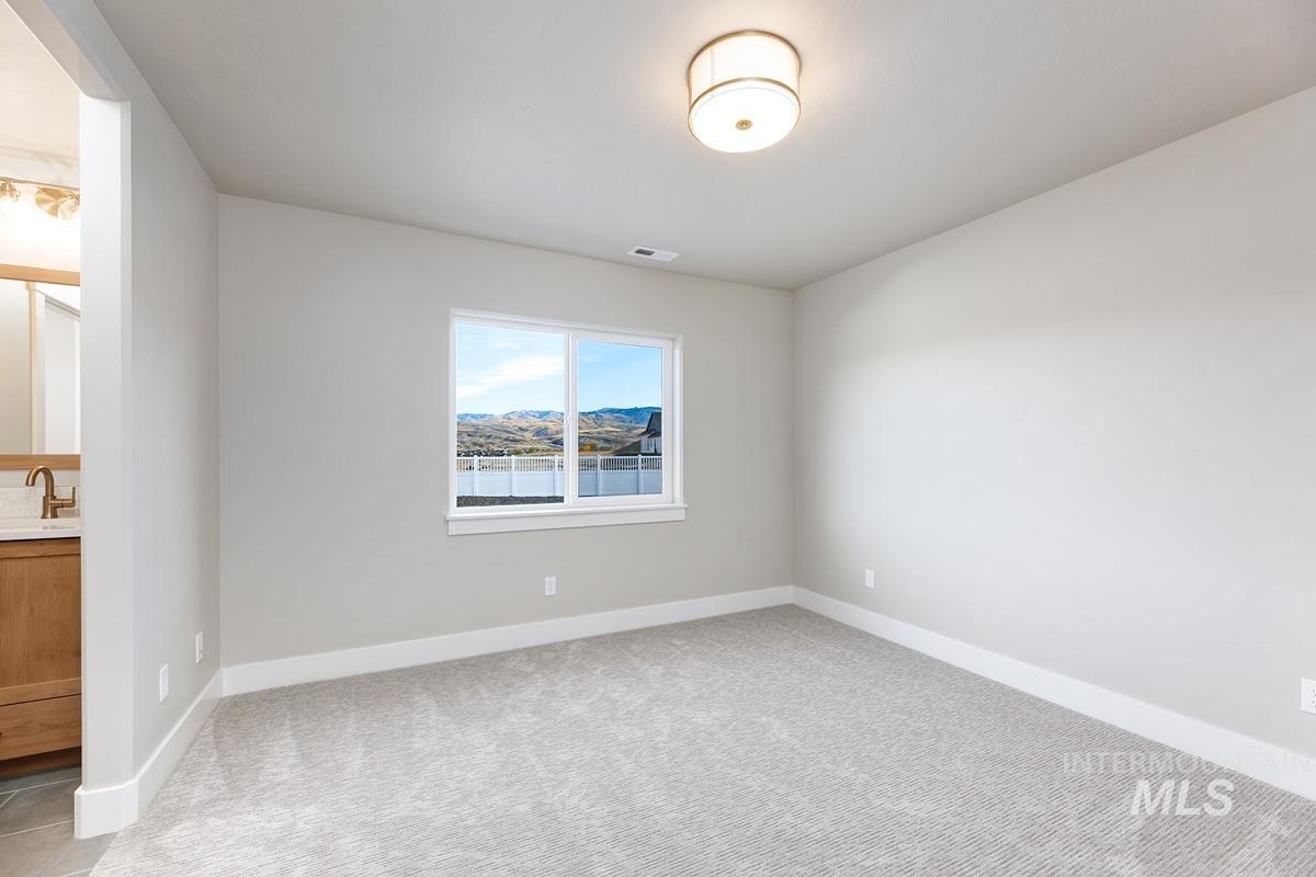 13544 North Ruffed Grouse Place Boise, ID 83714 - Photo 20 of 42 Unfurnished room with baseboards and light carpet