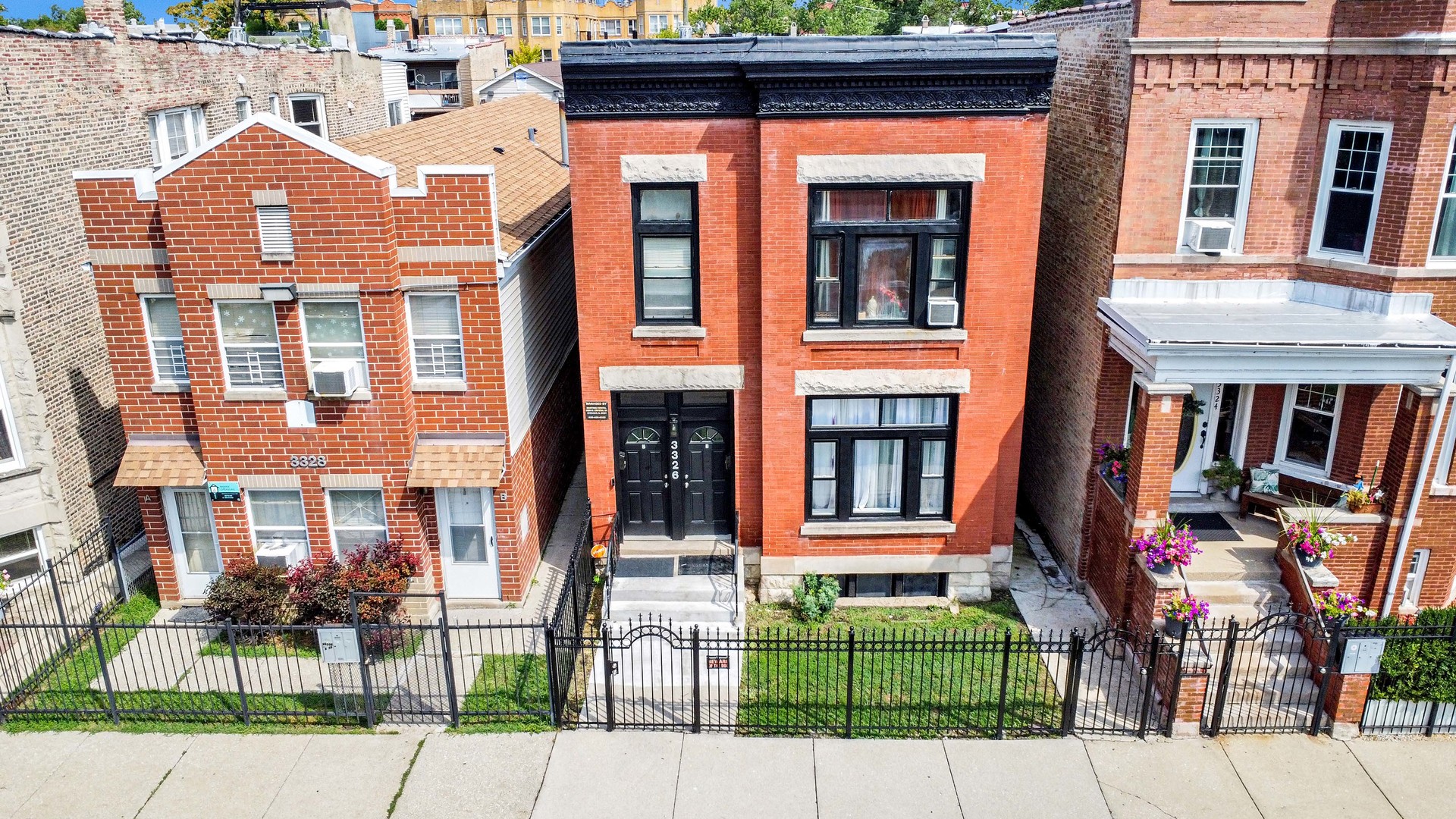 a front view of a residential apartment building with a yard