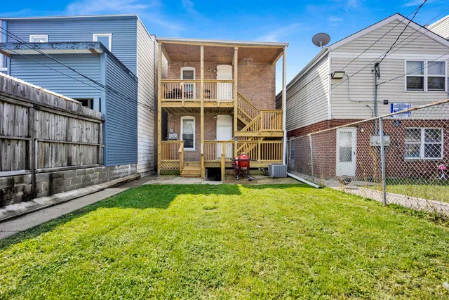 a view of a house with backyard and porch