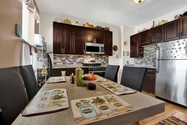 a kitchen with stainless steel appliances wooden cabinets and stove top oven
