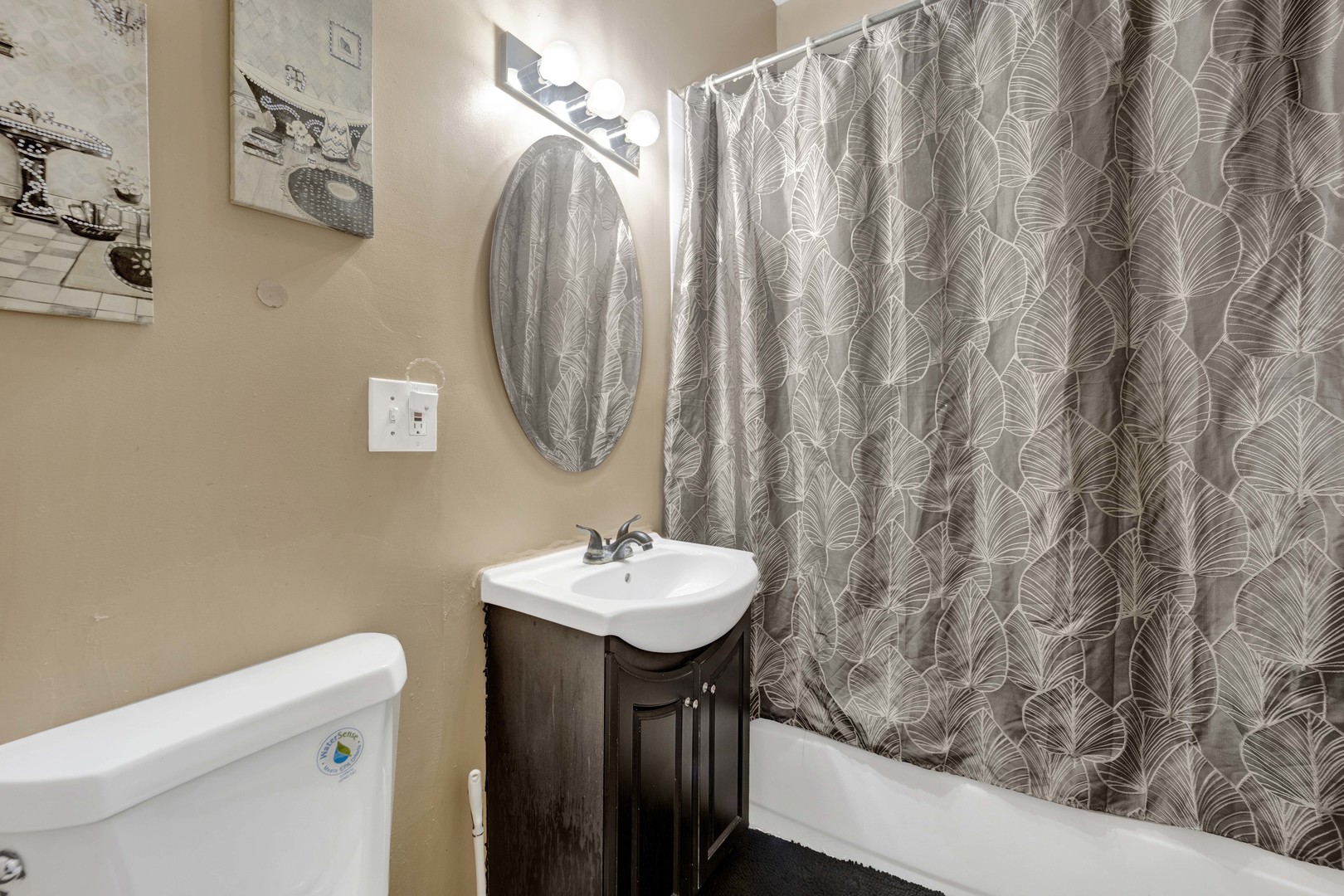 3326 West Crystal Street Chicago, IL 60651 - Photo 5 of 16 a bathroom with a sink a toilet and a mirror