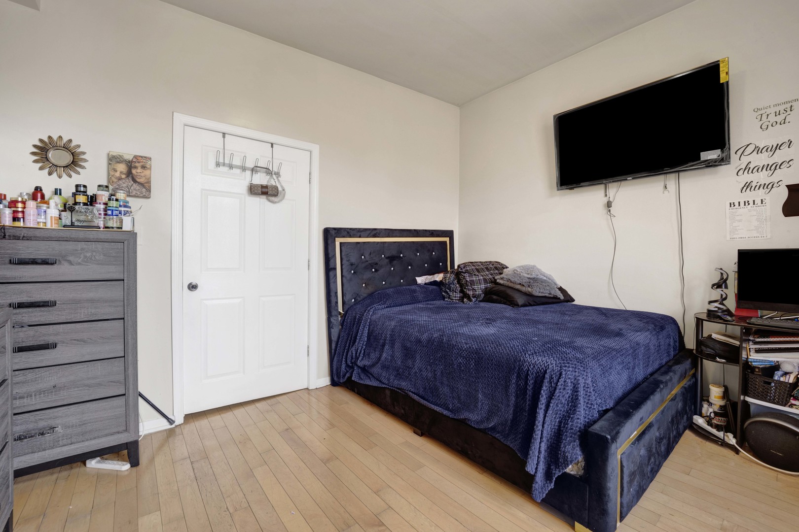 3326 West Crystal Street Chicago, IL 60651 - Photo 6 of 16 a bedroom with a bed a flat screen tv and a window