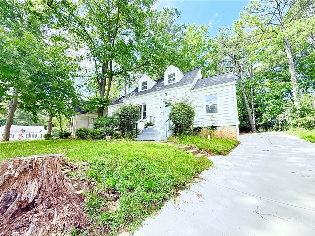 1679 Altadena Place Southwest Atlanta, GA 30311 - Photo 1 of 10 a front view of a house with garden
