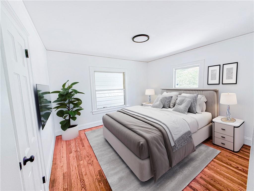 1679 Altadena Place Southwest Atlanta, GA 30311 - Photo 6 of 10 a bedroom with a bed and a potted plant