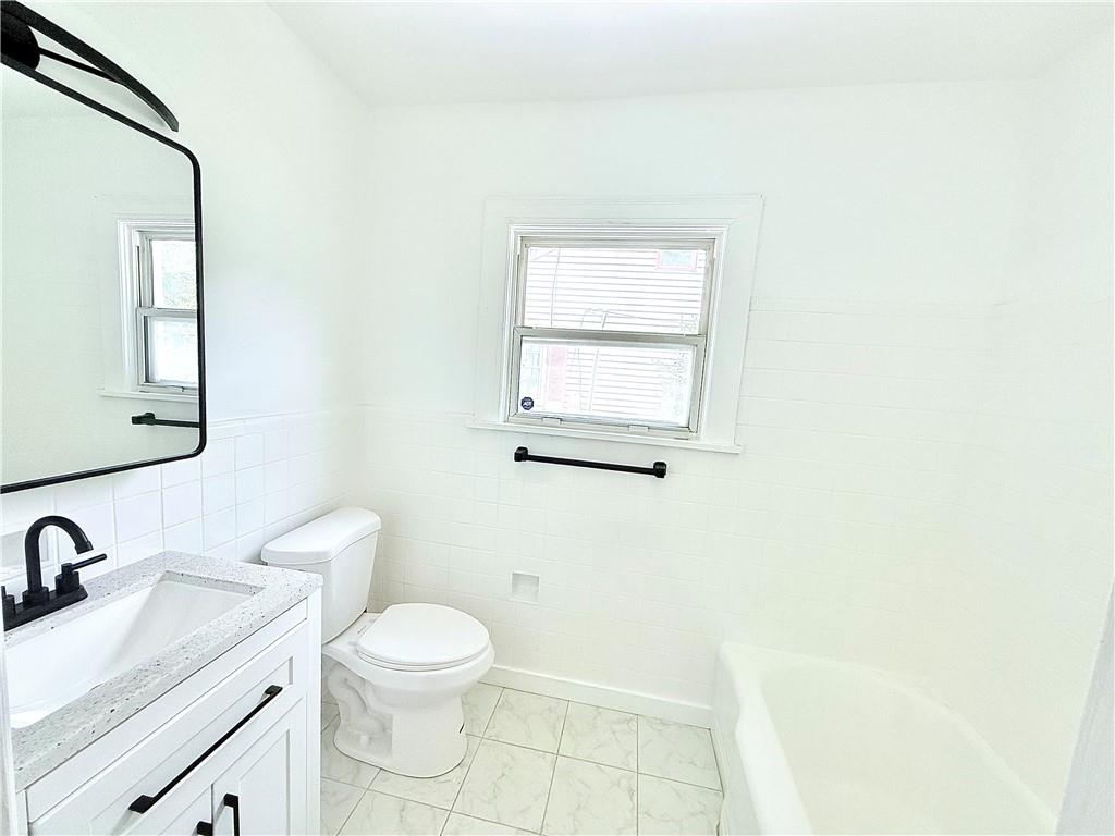 1679 Altadena Place Southwest Atlanta, GA 30311 - Photo 9 of 10 a bathroom with a toilet a sink and mirror