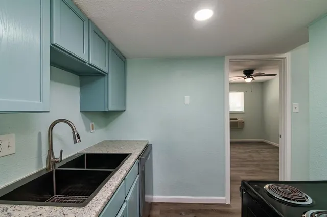 a kitchen with sink and cabinets