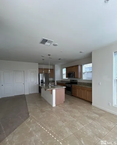 a kitchen with a refrigerator and a sink