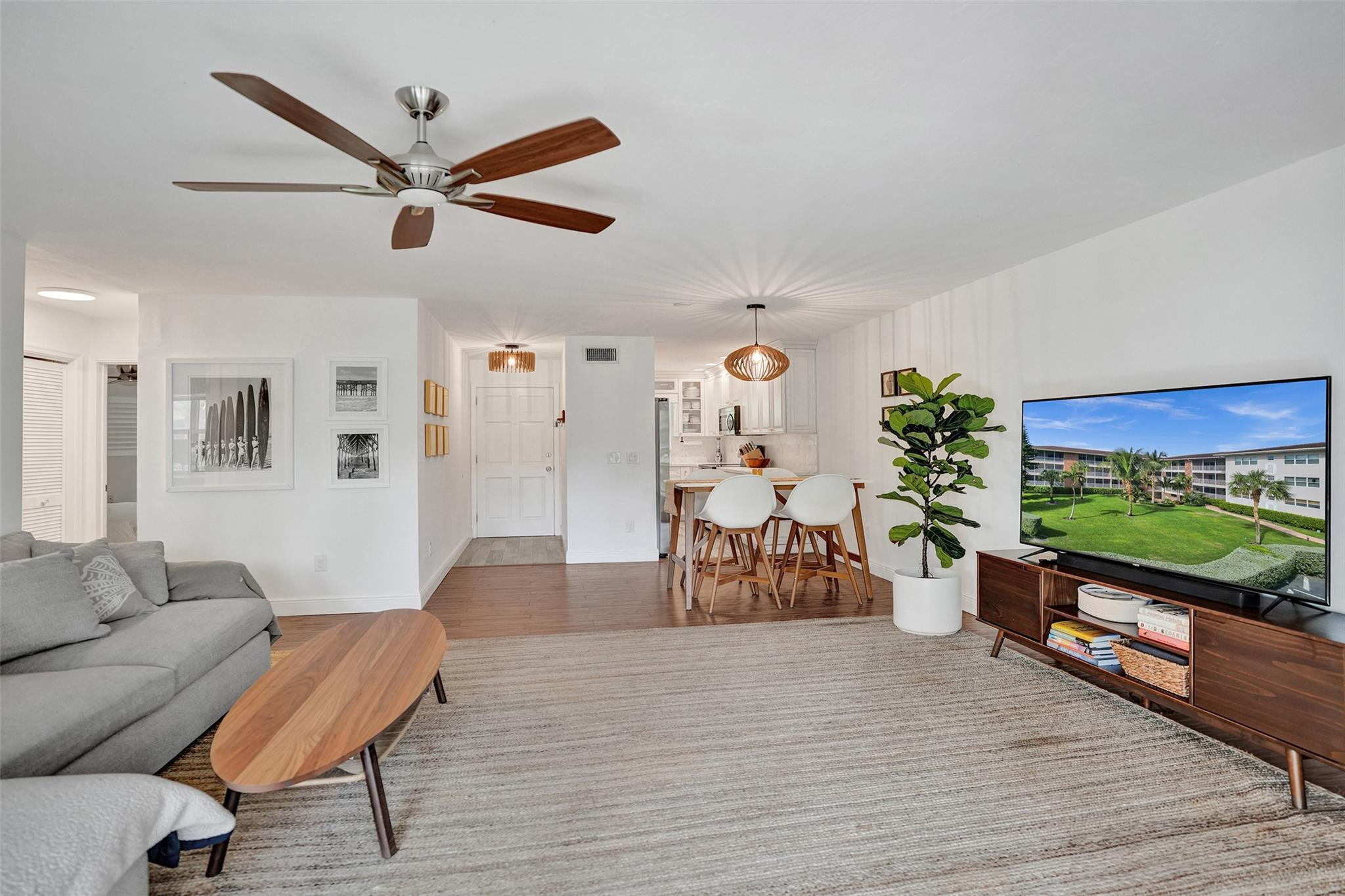 2501 South Ocean Boulevard, Unit 103 Boca Raton, FL 33432 - Photo 14 of 49 a living room with furniture and a flat screen tv