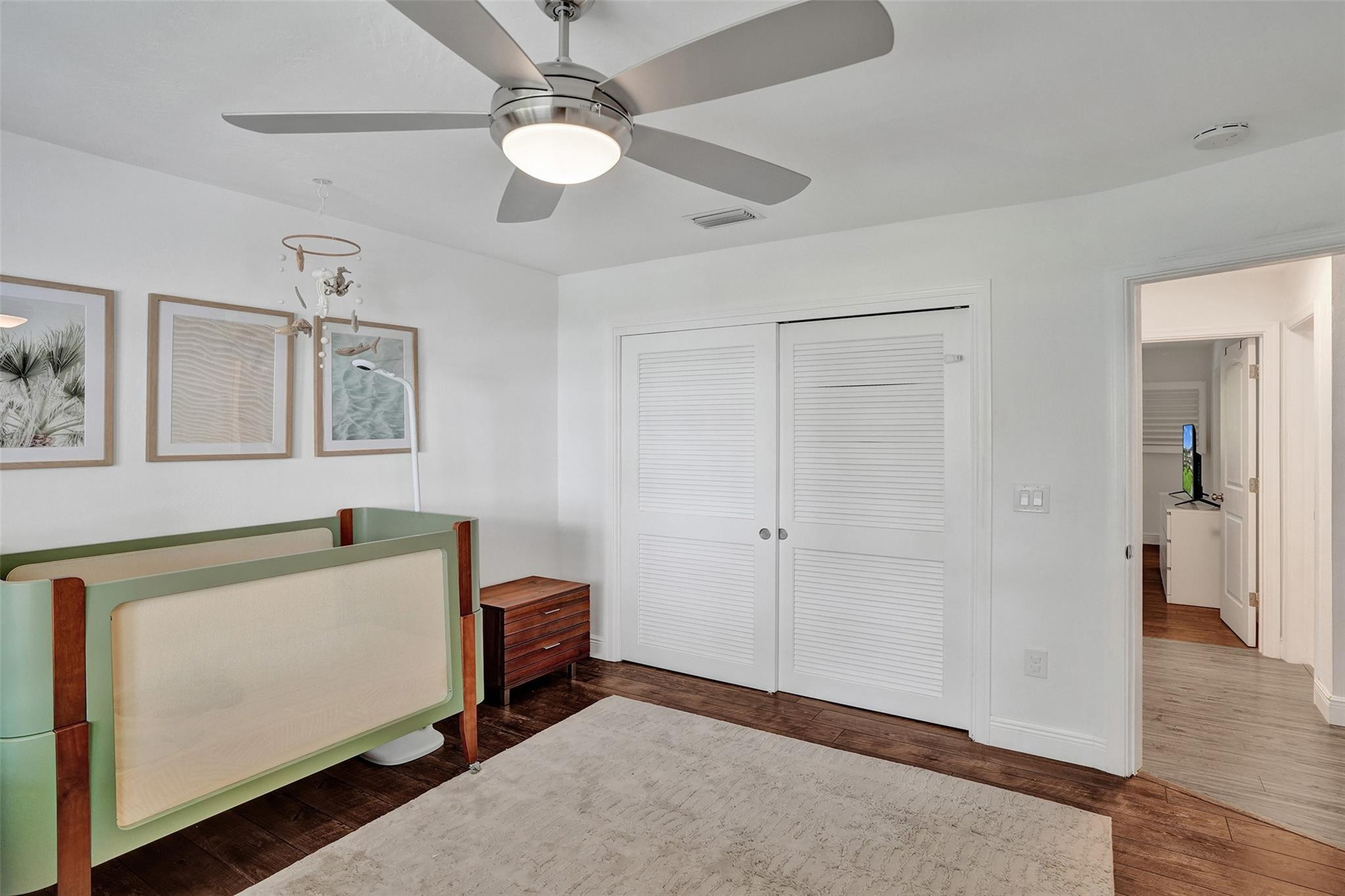 2501 South Ocean Boulevard, Unit 103 Boca Raton, FL 33432 - Photo 17 of 49 a bedroom with a bed and a chandelier