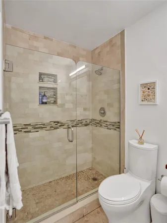 a bathroom with a sink toilet and mirror