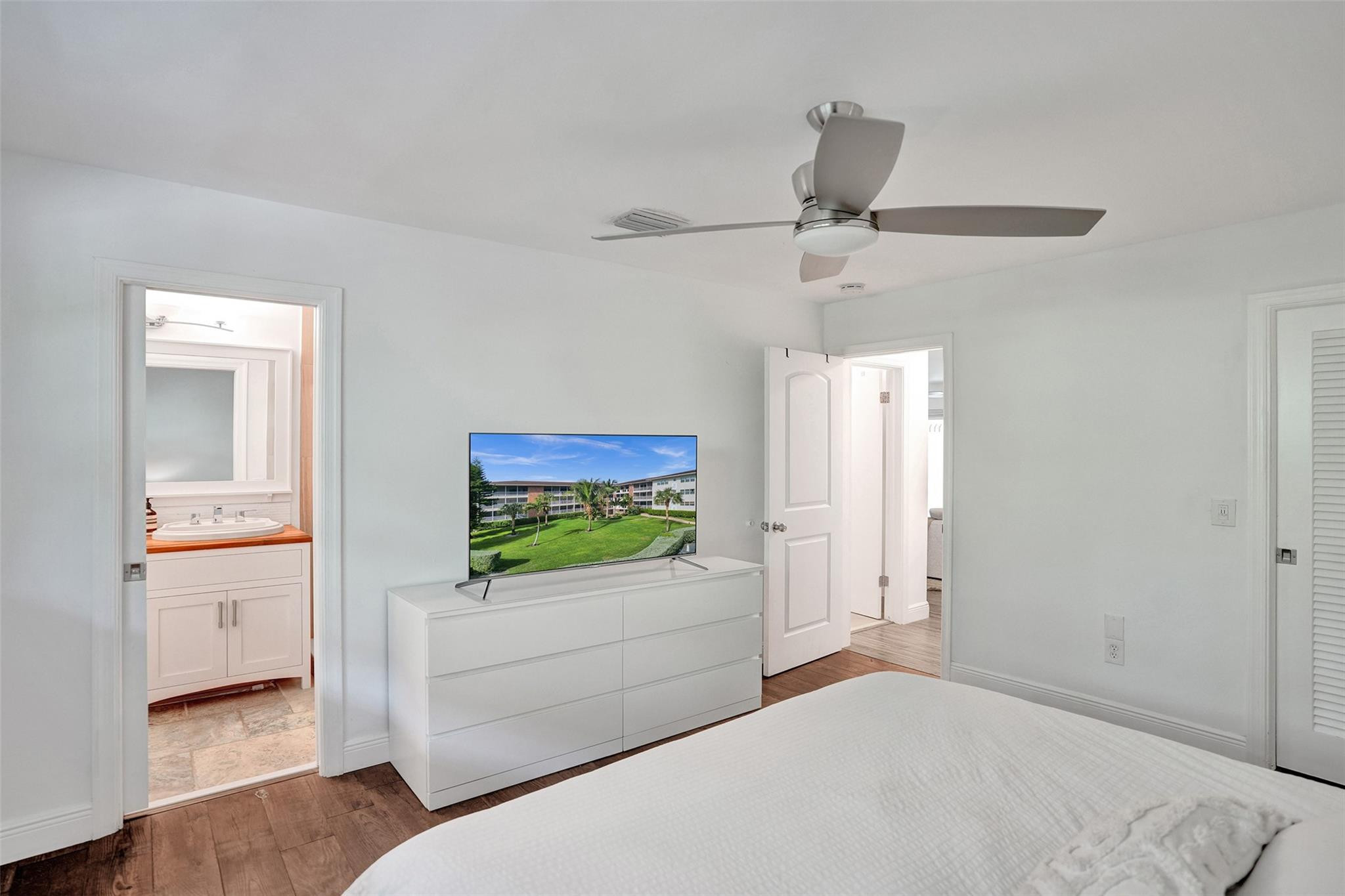 2501 South Ocean Boulevard, Unit 103 Boca Raton, FL 33432 - Photo 23 of 49 a bedroom with a bed and a view of bathroom