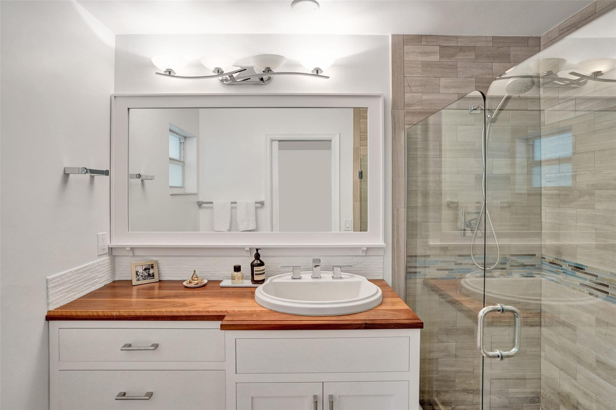 2501 South Ocean Boulevard, Unit 103 Boca Raton, FL 33432 - Photo 24 of 49 a bathroom with a sink and a mirror