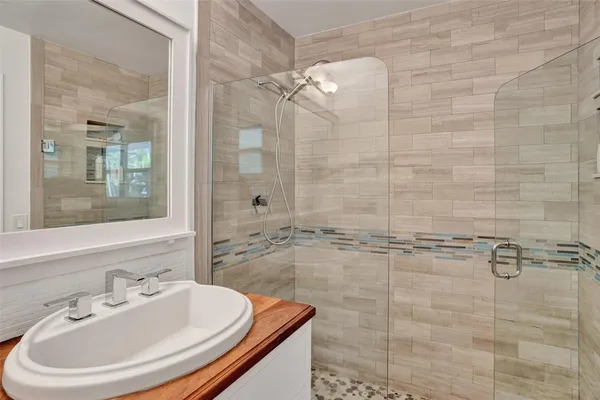 a bathroom with a shower and a sink
