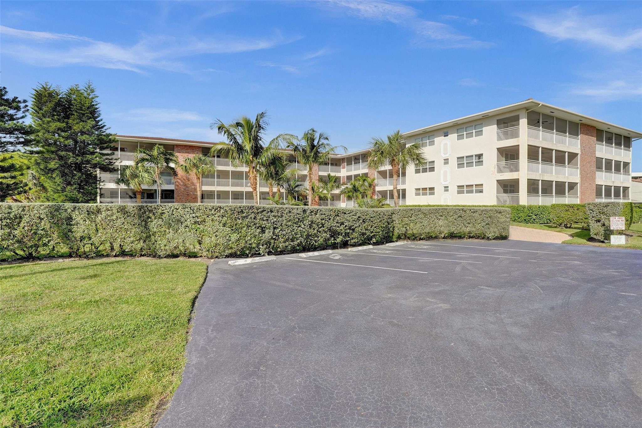 2501 South Ocean Boulevard, Unit 103 Boca Raton, FL 33432 - Photo 45 of 49 a view of a big building with a big yard and large trees