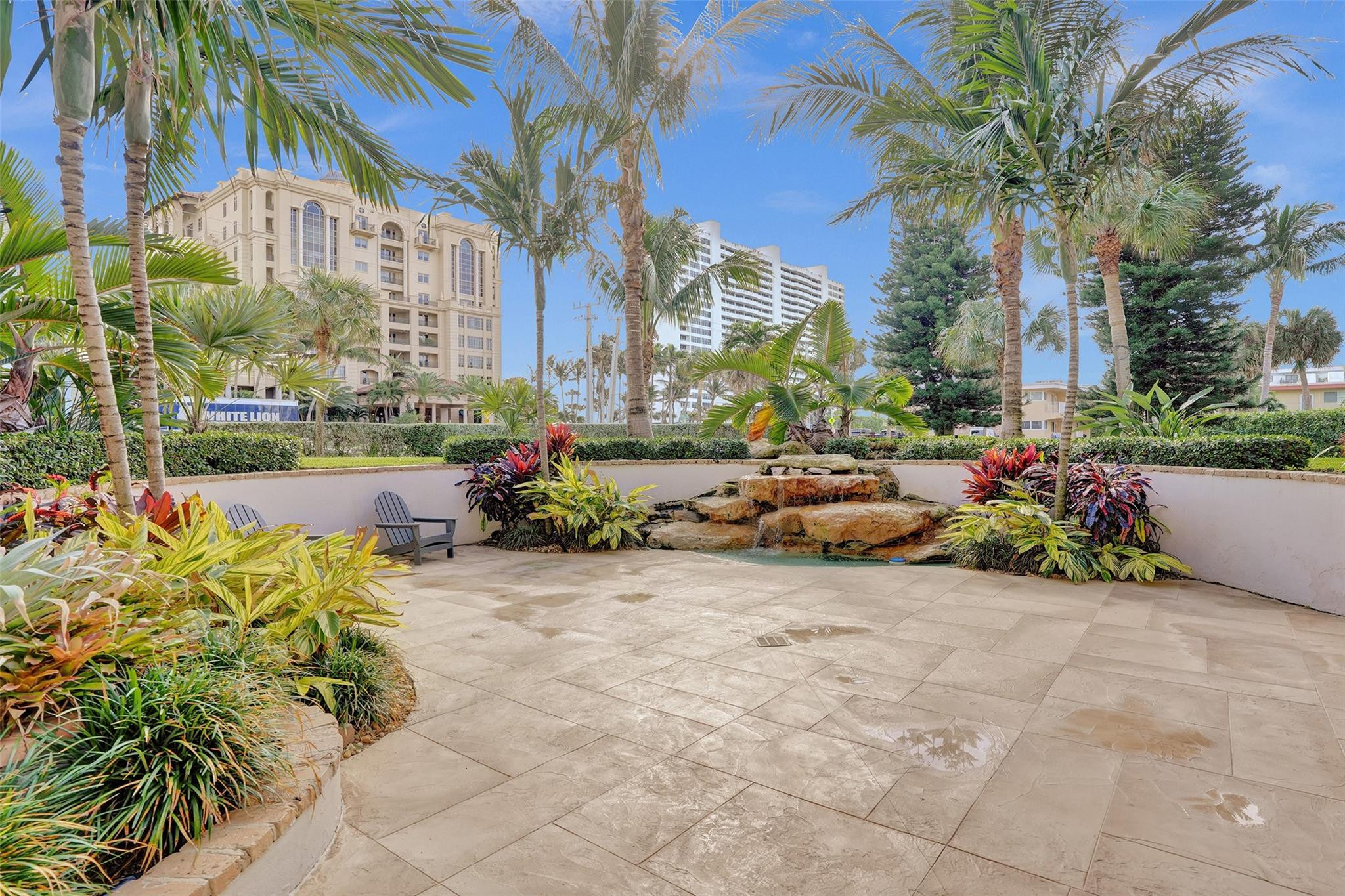 2501 South Ocean Boulevard, Unit 103 Boca Raton, FL 33432 - Photo 47 of 49 a row of yellow and trees in the patio of a building