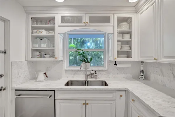 a kitchen with stainless steel appliances white cabinets and a stove top oven