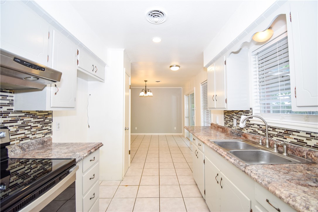 1209 Dallas Street Portland, TX 78374 - Photo 11 of 29 a kitchen with a sink stove and cabinets