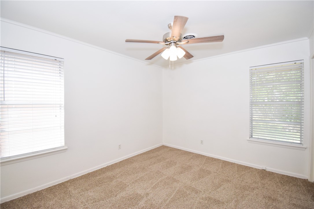 1209 Dallas Street Portland, TX 78374 - Photo 13 of 29 an empty room with a window and a fan