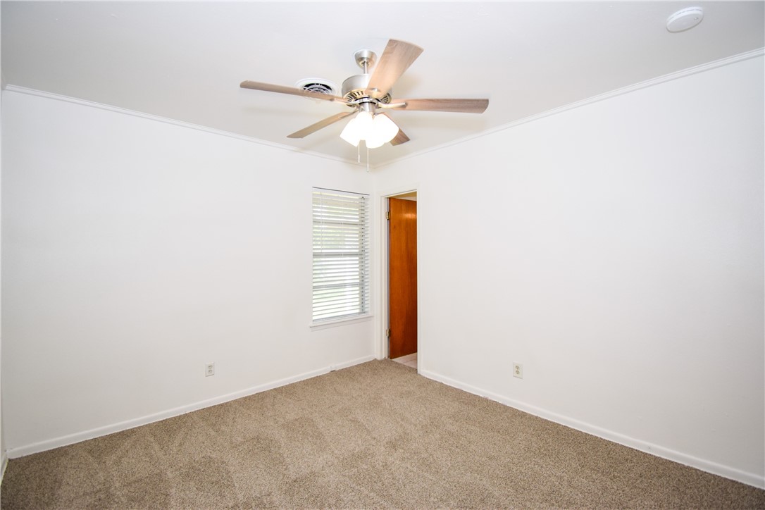 1209 Dallas Street Portland, TX 78374 - Photo 14 of 29 an empty room with windows and fan