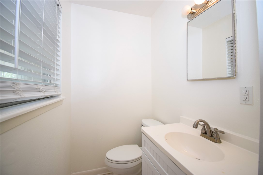 1209 Dallas Street Portland, TX 78374 - Photo 15 of 29 a bathroom with a sink a toilet and mirror