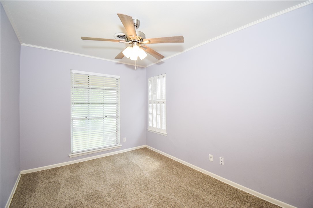 1209 Dallas Street Portland, TX 78374 - Photo 17 of 29 an empty room with windows and fan