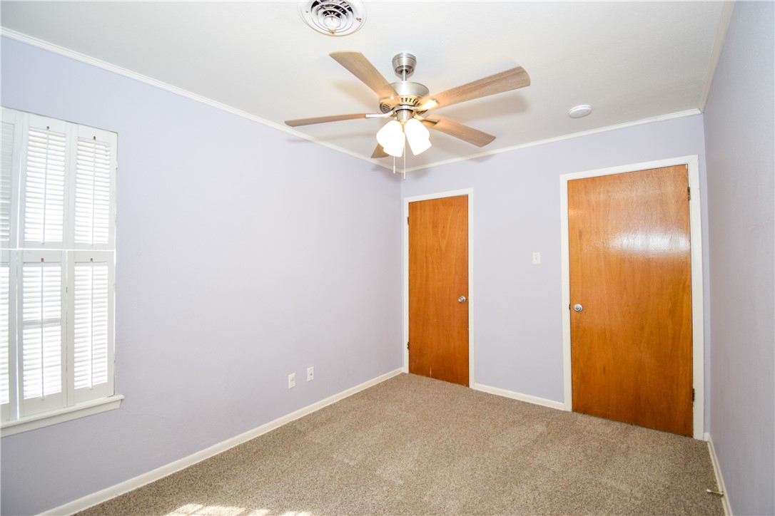 1209 Dallas Street Portland, TX 78374 - Photo 18 of 29 an empty room with windows and fan