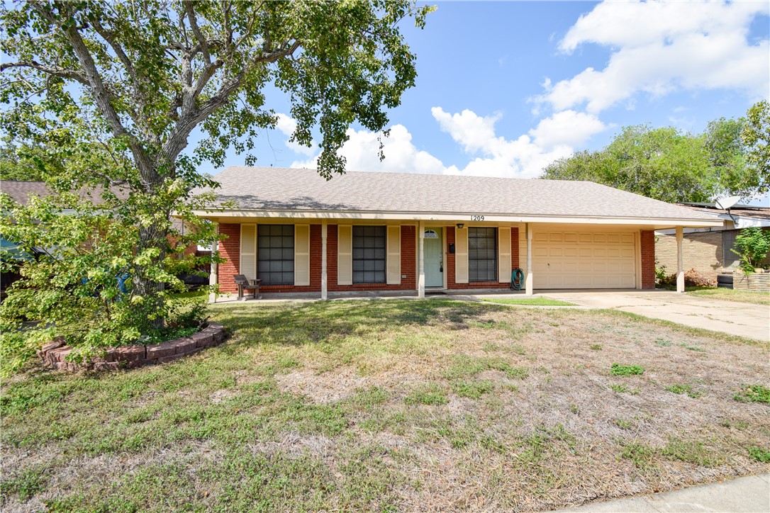 1209 Dallas Street Portland, TX 78374 - Photo 2 of 29 front view of a house with a garden