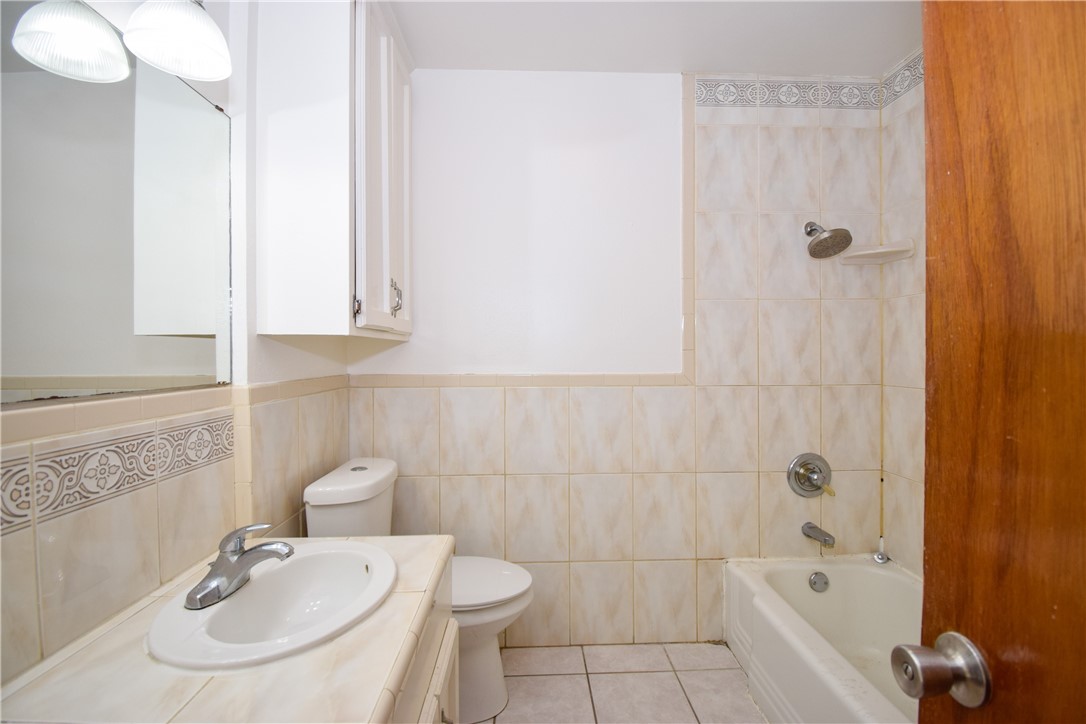 1209 Dallas Street Portland, TX 78374 - Photo 21 of 29 a bathroom with a sink a toilet and shower