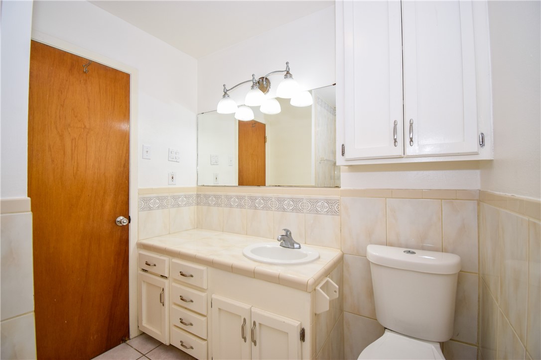 1209 Dallas Street Portland, TX 78374 - Photo 22 of 29 a bathroom with a sink vanity and a mirror