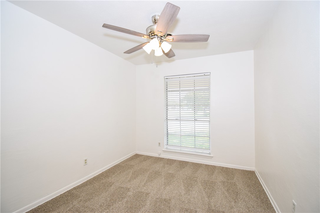 1209 Dallas Street Portland, TX 78374 - Photo 23 of 29 an empty room with windows and fan