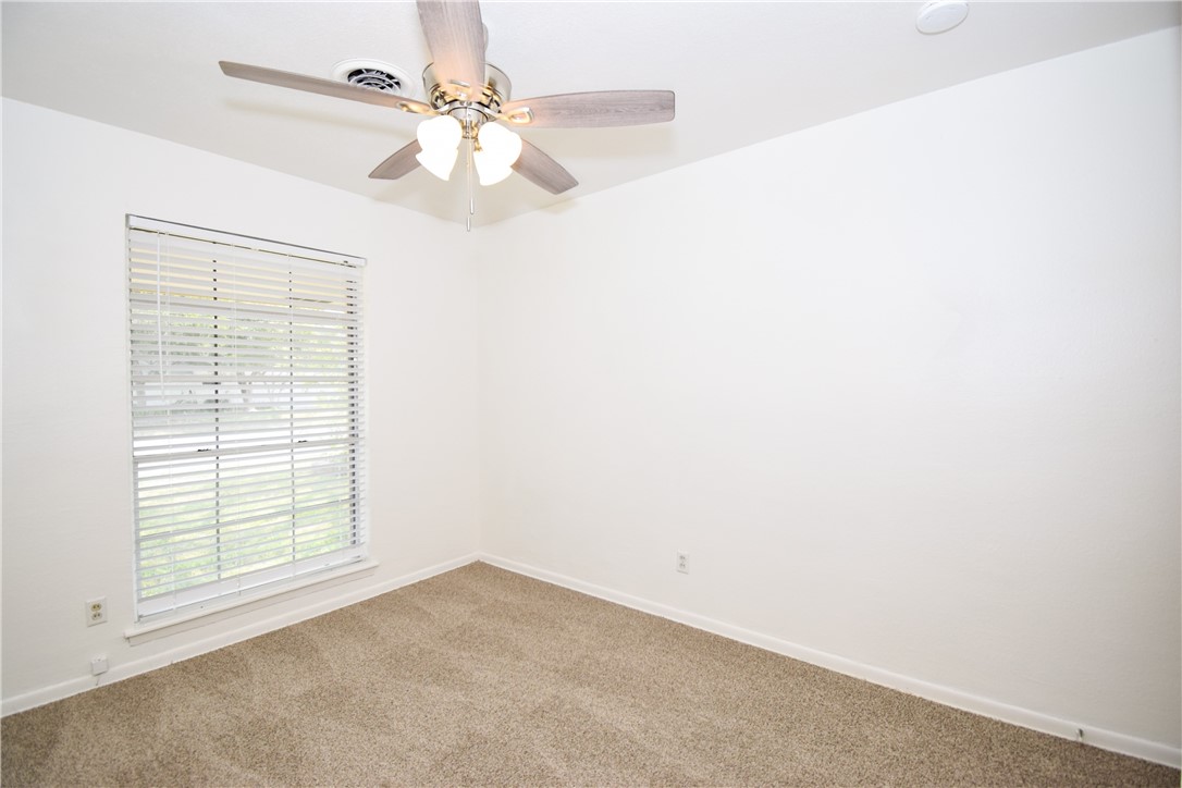 1209 Dallas Street Portland, TX 78374 - Photo 24 of 29 an empty room with windows and fan