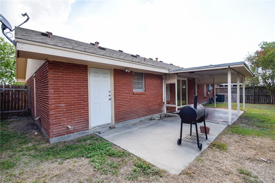 1209 Dallas Street Portland, TX 78374 - Photo 27 of 29 a backyard of a house with barbeque oven table and chairs