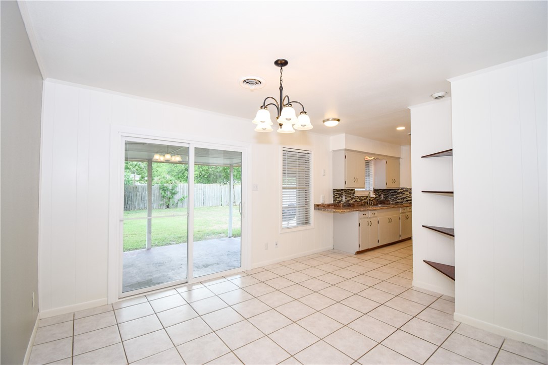 1209 Dallas Street Portland, TX 78374 - Photo 7 of 29 a large white kitchen with a sink and dishwasher a refrigerator with white cabinets