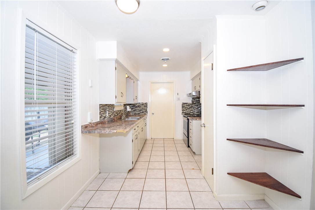 1209 Dallas Street Portland, TX 78374 - Photo 10 of 29 a kitchen with a refrigerator a sink and a stove