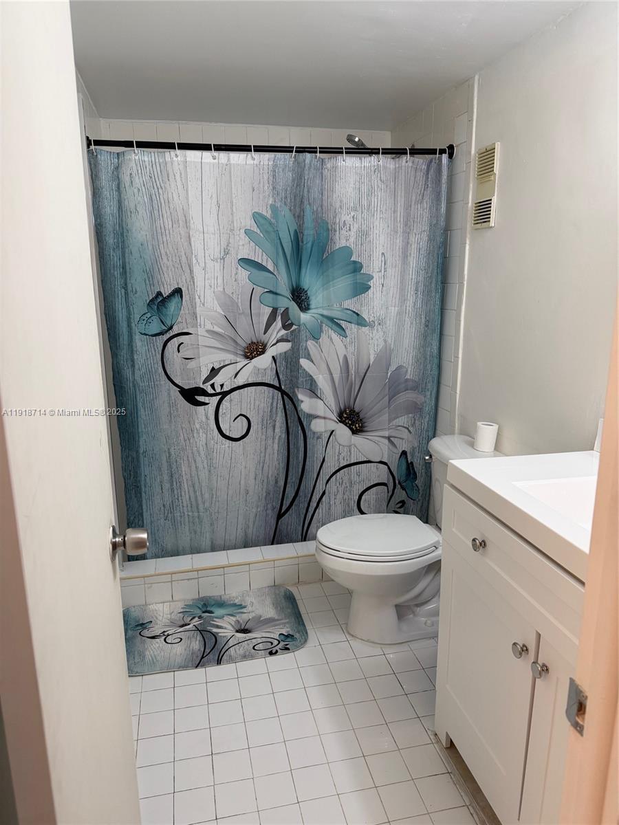 8411 Northwest 8th Street, Unit 405 Miami, FL 33126 - Photo 15 of 23 a bathroom with a toilet and a sink