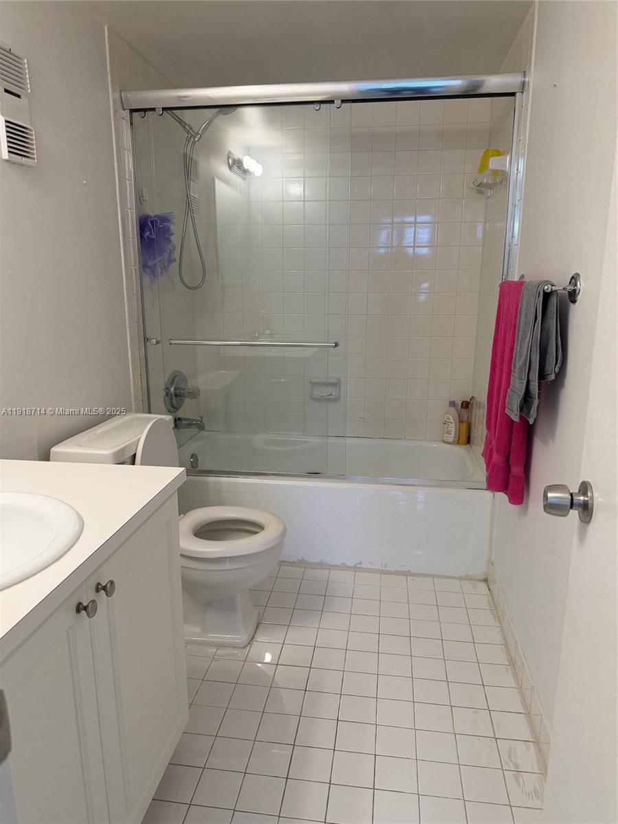 8411 Northwest 8th Street, Unit 405 Miami, FL 33126 - Photo 17 of 23 a bathroom with a granite countertop bathtub shower sink vanity and toilet