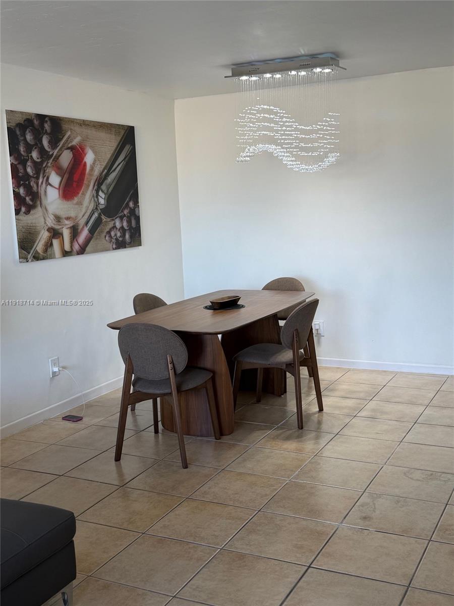 8411 Northwest 8th Street, Unit 405 Miami, FL 33126 - Photo 3 of 23 a room with a table and chairs