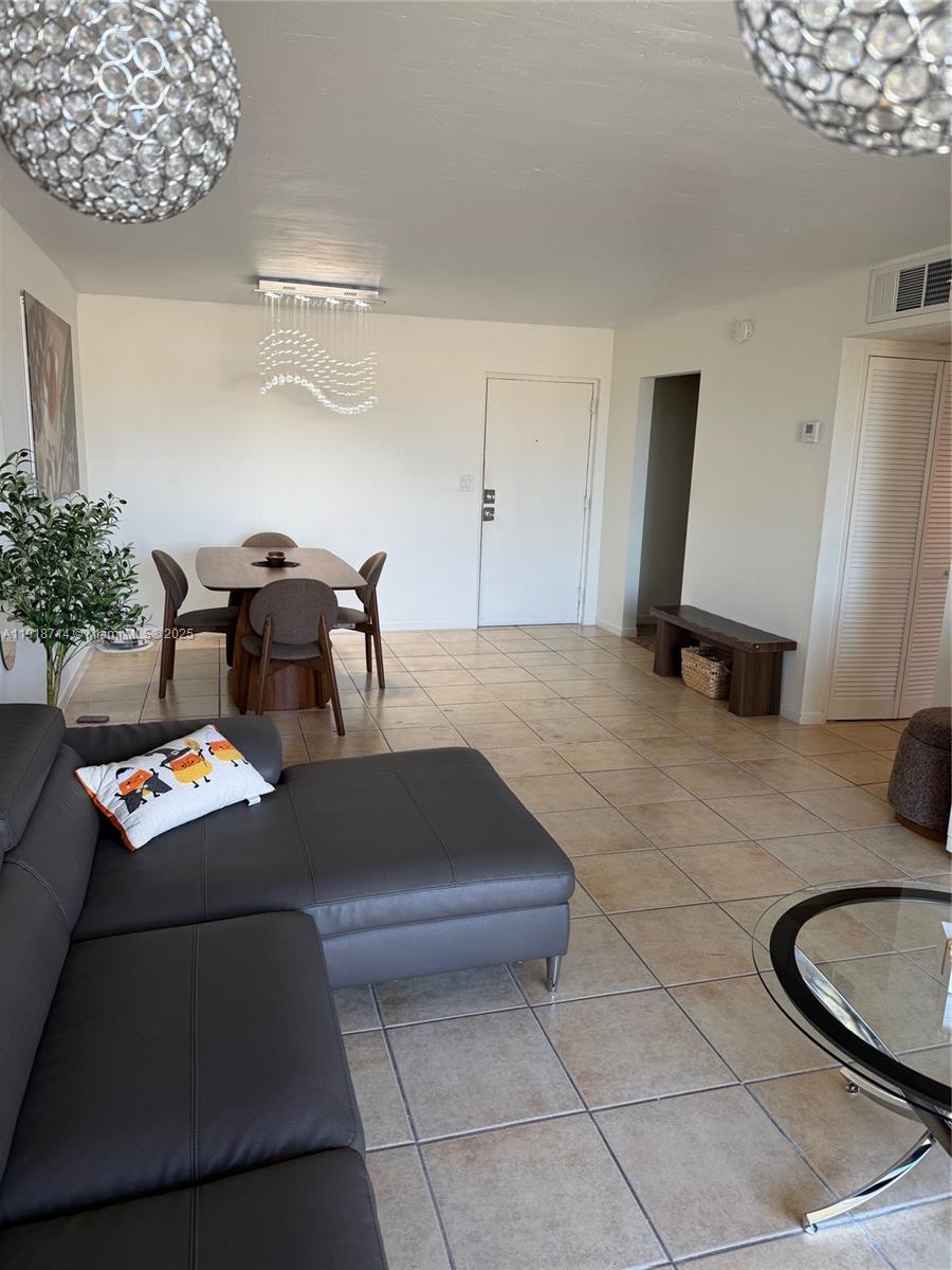 8411 Northwest 8th Street, Unit 405 Miami, FL 33126 - Photo 8 of 23 a living room with furniture and a table