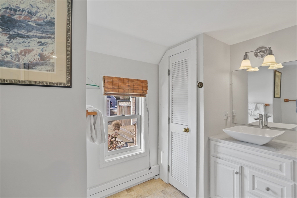 28 Crocker Drive Edgartown, MA 02539 - Photo 16 of 24 a bathroom with a granite countertop sink a mirror and a shower