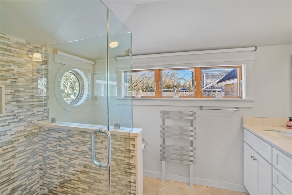 28 Crocker Drive Edgartown, MA 02539 - Photo 18 of 24 a bathroom with a granite countertop sink mirror and a shower