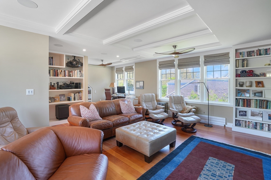 28 Crocker Drive Edgartown, MA 02539 - Photo 8 of 24 a living room with furniture a rug and a book shelf