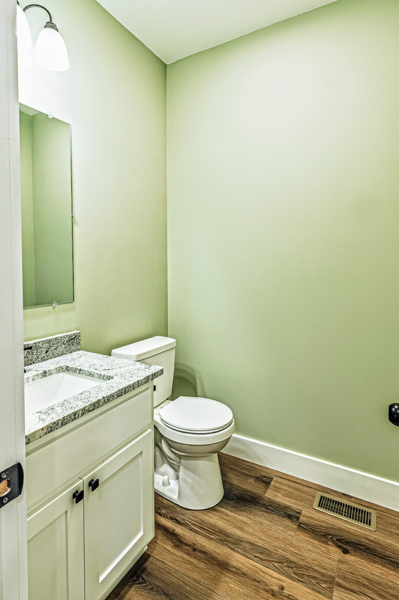 1875 Rocky Hollow Road Erin, TN 37061 - Photo 21 of 31 a bathroom with a granite countertop toilet and a sink