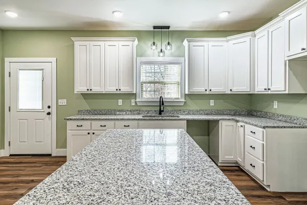 a kitchen with stainless steel appliances granite countertop a sink and cabinets