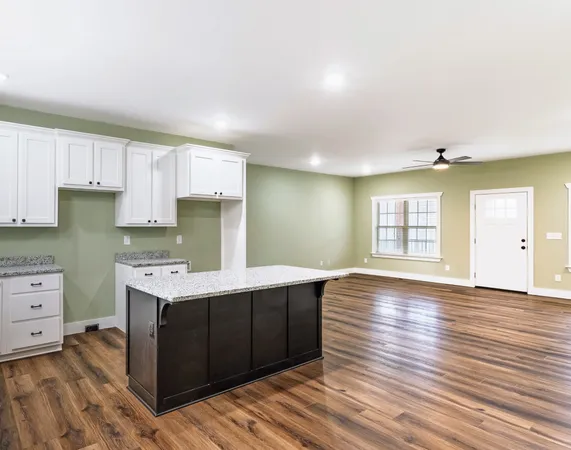 a kitchen with wooden floors and cabinets
