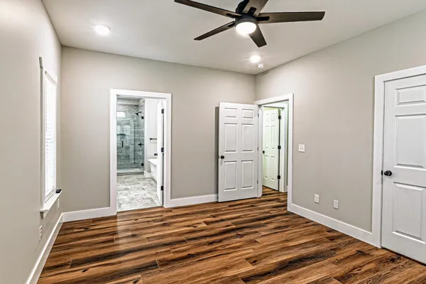 a view of a room with wooden floor and bedroom